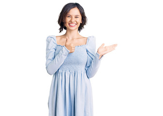 Young beautiful girl wearing casual clothes showing palm hand and doing ok gesture with thumbs up, smiling happy and cheerful