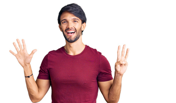 Handsome hispanic man wearing casual clothes showing and pointing up with fingers number eight while smiling confident and happy.