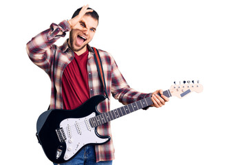 Young handsome man playing electric guitar smiling happy doing ok sign with hand on eye looking through fingers