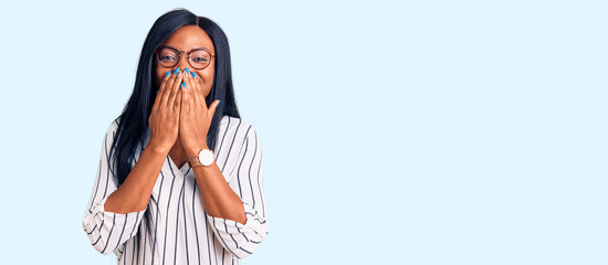 Young african american woman wearing casual clothes and glasses laughing and embarrassed giggle...