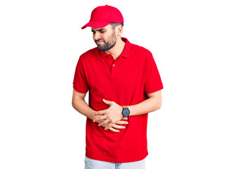 Young handsome man with beard wearing delivery uniform with hand on stomach because indigestion, painful illness feeling unwell. ache concept.