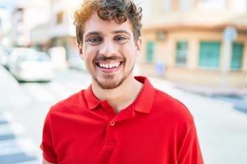 Young handsome caucasian man smiling happy walking at city.