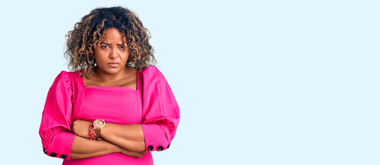 Young african american plus size woman wearing casual clothes skeptic and nervous, disapproving expression on face with crossed arms. negative person.