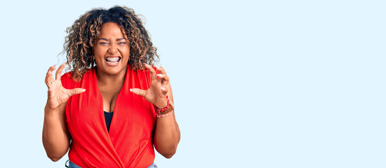 Young african american plus size woman wearing casual style with sleeveless shirt smiling funny doing claw gesture as cat, aggressive and sexy expression