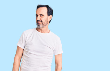 Obraz premium Middle age handsome man wearing casual t-shirt looking sleepy and tired, exhausted for fatigue and hangover, lazy eyes in the morning.
