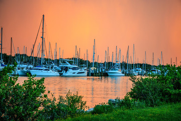 Boats moored at the marina during sunset