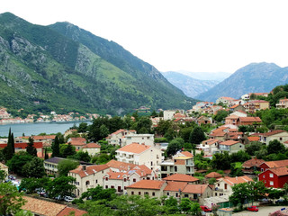Fototapeta na wymiar Aerial view of Kotor bay and old city in Kotor, Montenegro. Kotor is a coastal town in a secluded Gulf of Kotor, its preserved medieval old town is an UNESCO World Heritage Site. 