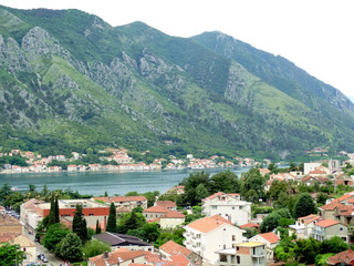 Fototapeta na wymiar Aerial view of Kotor bay and old city in Kotor, Montenegro. Kotor is a coastal town in a secluded Gulf of Kotor, its preserved medieval old town is an UNESCO World Heritage Site. 