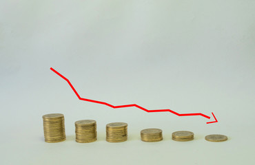 graph with coins in concept of economy in tailspin or bankruptcy