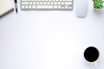 White office desk table. Workspace with computer keyboard, mouse and notebook with equipment other office supplies.