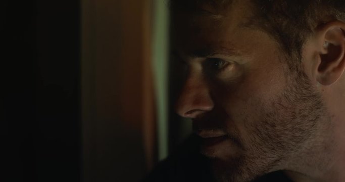 White Man Stares out the Window With Creepy Longing Frustration Moody Lighting