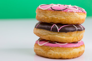 Colorful donuts stacked isolated on white