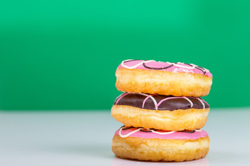 Colorful donuts stacked isolated on white