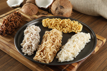 Cocada, coconut candy. Composition on wooden background