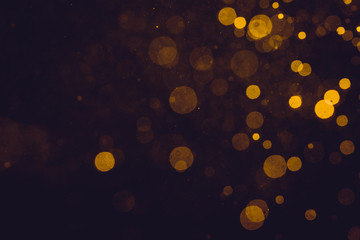 Fantasy gold bokeh sparkle from light on black