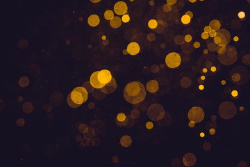 Fantasy gold bokeh sparkle from light on black