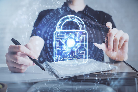 Double exposure of man hands holding a credit card and lock drawing. E-commerce and technology security concept.