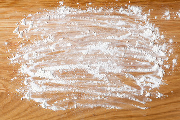 wheat flour on a wood board. top view.