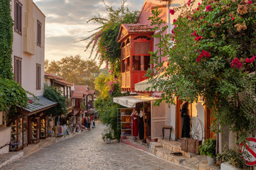 Beautiful street in the Kas old town with boutique shops at sunset, Turkey - obrazy, fototapety, plakaty