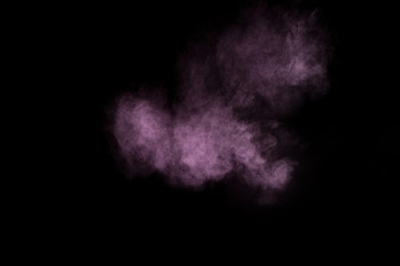 Purple powder explosion on black background. Colored powder cloud. Colorful dust explode. Paint Holi.