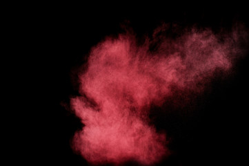 Fototapeta premium Red and pink powder explosion on black background. Colored powder cloud. Colorful dust explode. Paint Holi.