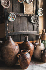 Many unique handmade clay jugs and vases on local arabian market. Souk in medina Marrakech.