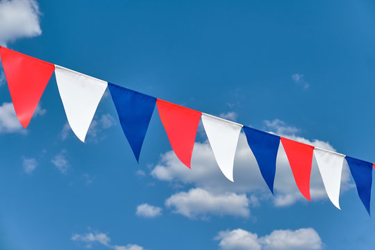 Red white and blue triangular bunting on sky background