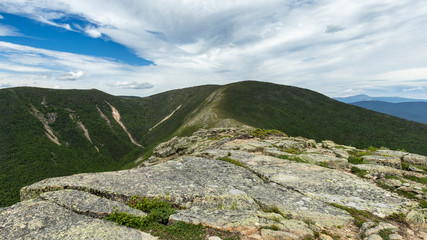 The rocky, lichen-covered top of Bondcliff extends along the ridgeline to Mount Bond and West Bond.