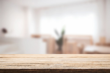Empty wooden desk space and blurry background of cafe or Restaurant for product display montage.