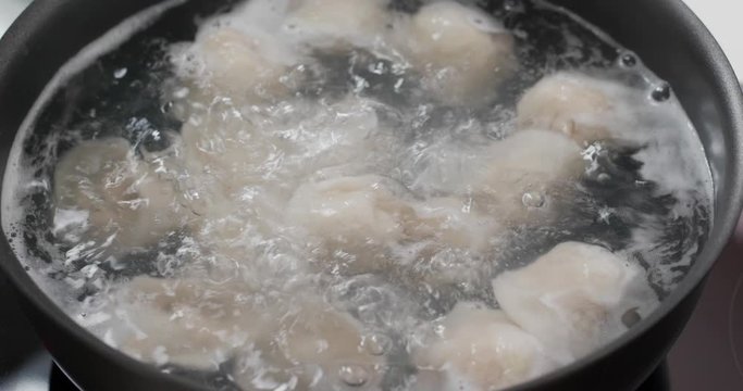 Cooking with meat dumpling in kitchen
