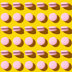 Seamless regular creative pattern of colorful french cookies macarons.