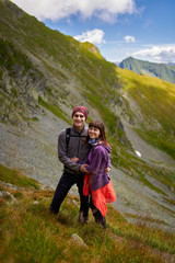 Naklejka na ściany i meble Hiking couple in the mountains