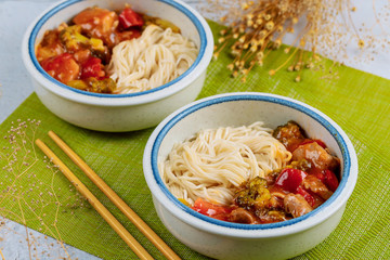 Japanese rice noodles with stir fry vegetable in bowl.