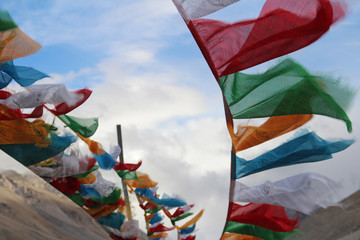Tibetan prayer flags fluttering against the cloudy sky, Tibet