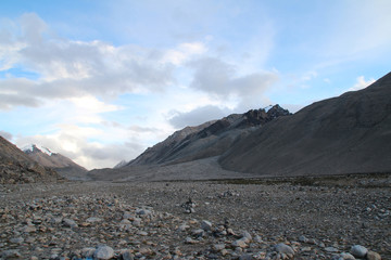 View of Mount Everest with the clouds and a bus from Everest Base Camp, Tibet