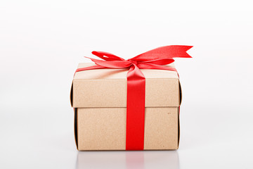 Gift box with red bow tie on white background