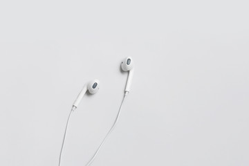 White headphones flat lay minimalism concept with copy space on white background