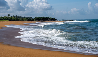 Waves crash on the golden sandy beach at Kalutara in western Sri Lanka