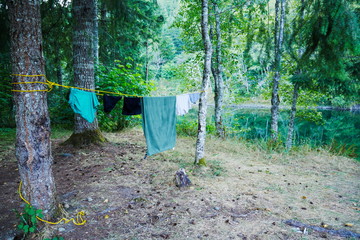 Clothes drying on a line at a campsite in a forest