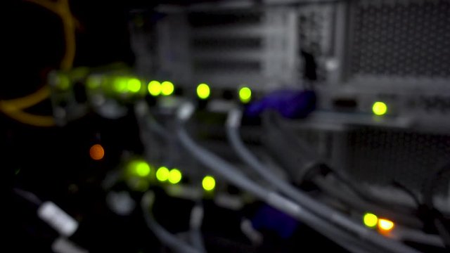 Blurred server rack. Blink green led. Many cable