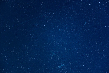 Starry sky at night with falling star. Astrophotography background 