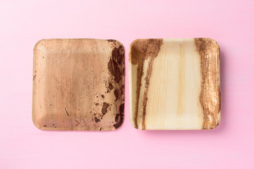 Back and front of betel palm leaf plate (Biodegradable plate, Compostable plate or Eco friendly disposable plate) on pink background
