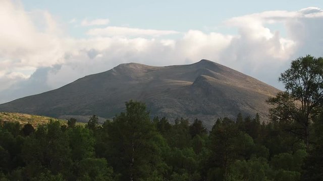 Time Lapse of the clouds in the mountains of Norway in Scandinavia with a forrest in front