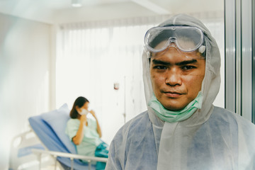 Fototapeta na wymiar Portrait of a male doctor with weariness, weary face and scars from wearing a mask, always working, to take care of female patients with the Coronavirus Covid-19 flu at a hospital detention facility.