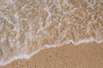 sea waves on a sandy shore in the afternoon