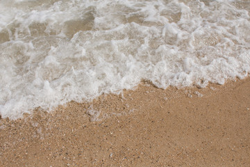 sea waves on a sandy shore in the afternoon