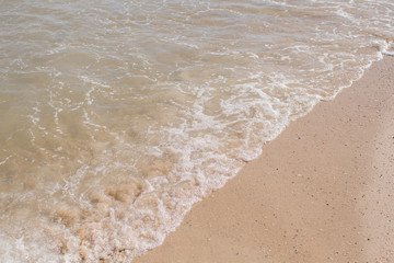 sea waves on a sandy shore in the afternoon