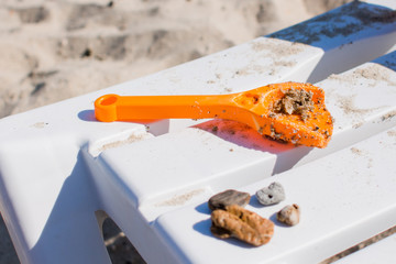 children's shovel in the sand on the beach