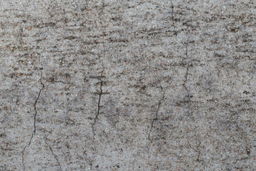 Cement surface walls have gray cracks.