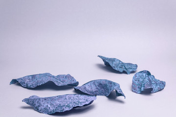 Beautiful faded old leafs in blue light. Minimalism autumn style concept. Background pattern for...